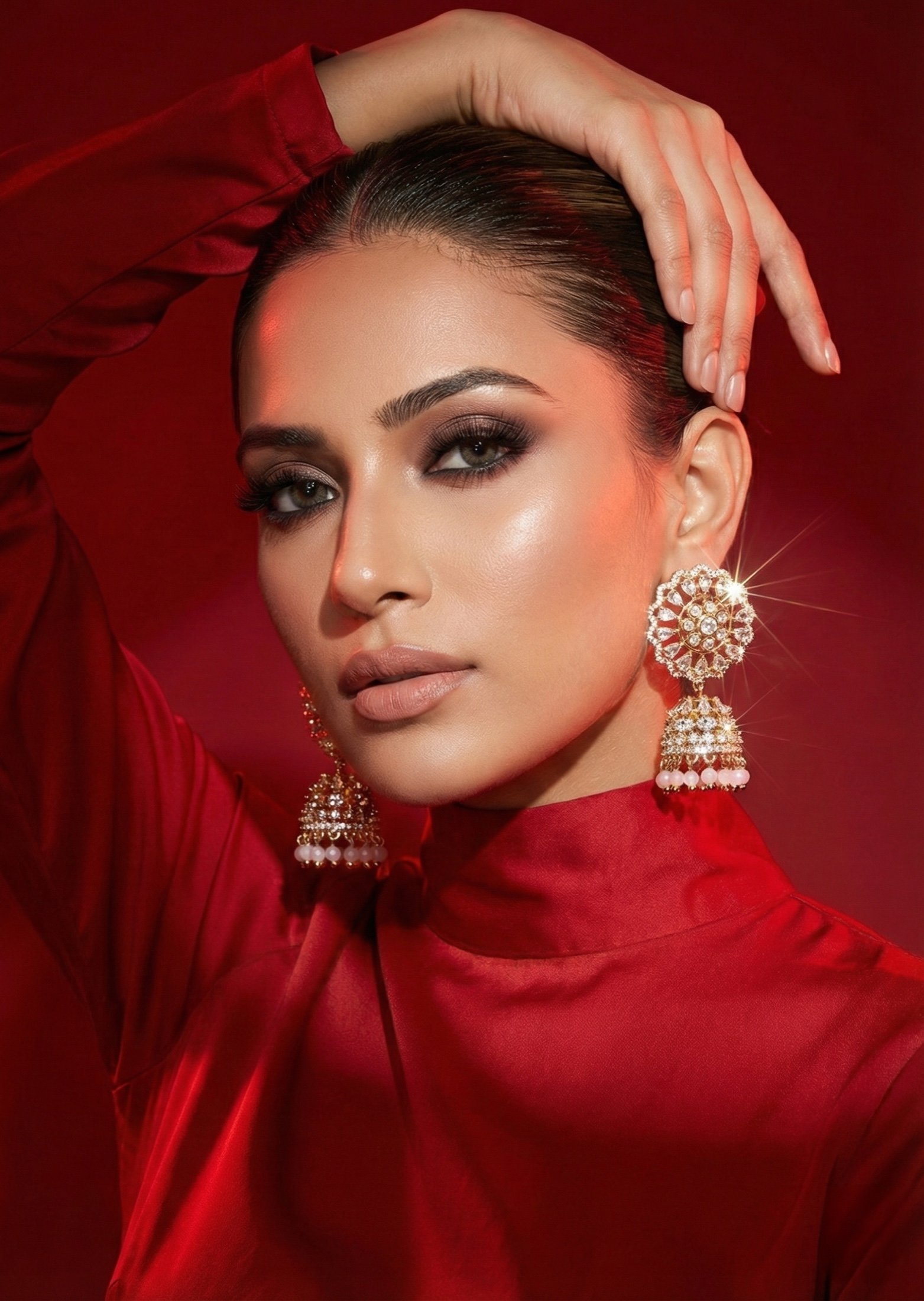 Model in red with statement jhumka earrings